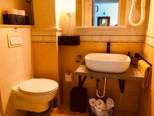 a bathroom with a white toilet and a sink at Flower House - Lapad in Dubrovnik