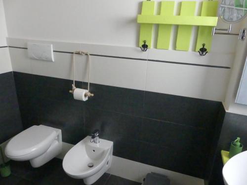a bathroom with a white toilet and a sink at A Casa di Lu in Minervino di Lecce