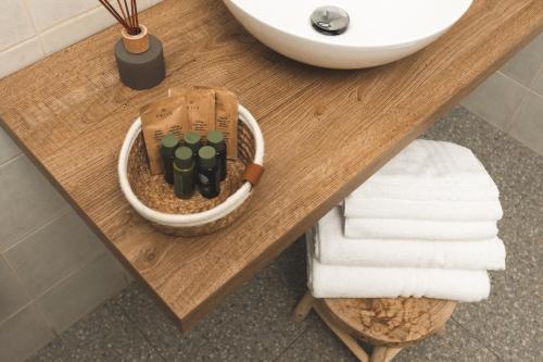 a table in a bathroom with a sink and towels at i Cacciagalli Wine Resort in Teano