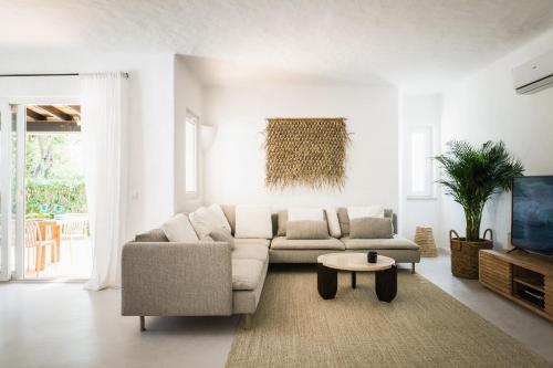 a living room with a couch and a table at The Carobs Villa in Carvoeiro