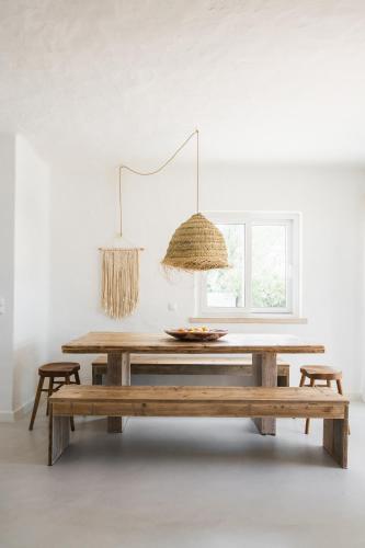 a dining room table with two chairs and a window at The Carobs Villas in Carvoeiro