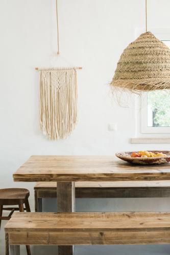 a kitchen with a wooden table with a plate of fruit at The Carobs Villas in Carvoeiro