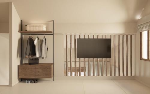 a living room with a television on a wall at Palma Seaside Villa 3 in Sarti