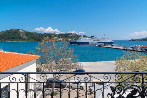 a cruise ship is docked in a harbor at Megaron Skiathos Boutique Residence in Skiathos