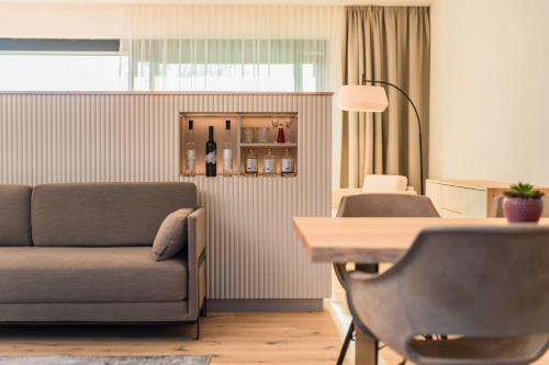 a living room with a couch and a table at Lind Fruchtreich in Sebersdorf