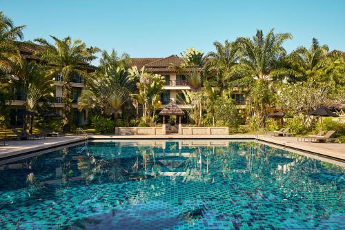 a swimming pool in front of a resort at ROBINSON KHAO LAK in Khao Lak