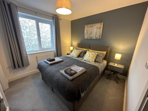 a bedroom with a bed with a tray on it at 3 Bed Home Sleeps 6 - Long Stays - Contractors & Relocators with Parking, Garden & WiFi in Milton Keynes