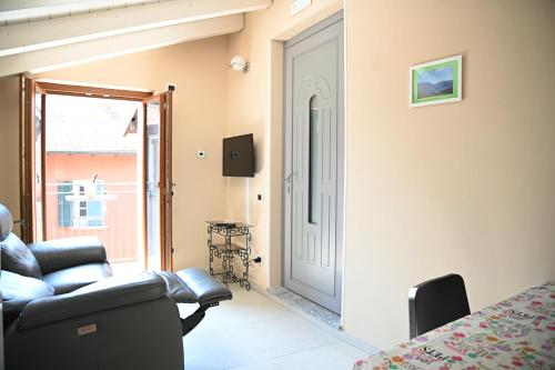 - un salon avec un canapé et une porte dans l'établissement La Stalletta, à Menaggio