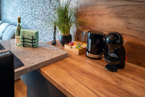 a counter top with a coffee maker and a bottle of wine at Apartment Luxury Vision in Varna City