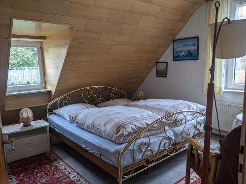 a bedroom with two beds in a attic at Pension Haus Martha in Bad Grund