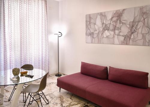 a living room with a couch and a table at Hotel Exclusive in Agrigento