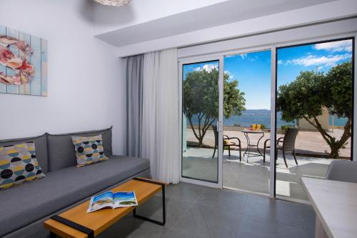 a living room with a couch and a table at Balos Beach in Kissamos