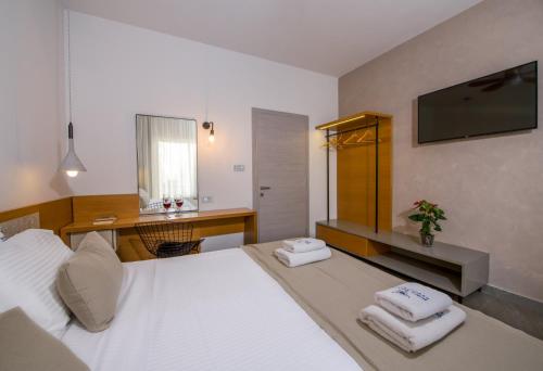 a bedroom with a bed with two towels on it at Balos Beach in Kissamos