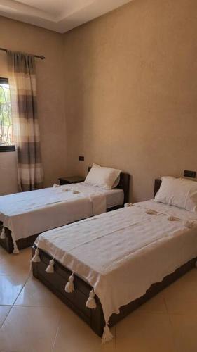 a bedroom with two beds in a room at Villa privative tortues2 piscine chauffée 35min Marrakech in Marrakech