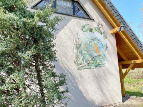 a painting of a fish on the side of a building at Ferienhaus Eisvogel in Lübbenau