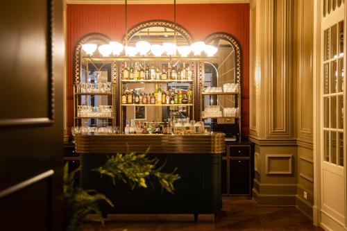 a bar in a room with orange walls at Maalot Roma - Small Luxury Hotels of the World in Rome