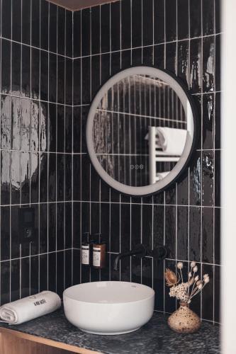 a bathroom with a sink and a mirror at La Voie Lactée in La Mongie