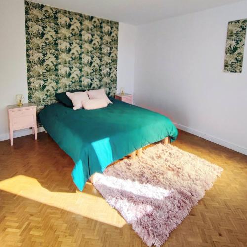 - une chambre avec un lit doté d'une couverture verte et d'un tapis dans l'établissement La Villa Loha - Maison De Vacances, à Saint-Gaudens