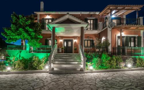 a house with stairs in front at night at Amalthia Villa in Mouzákion