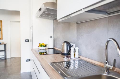 a kitchen with a sink and a counter at Outdooredo Garda Apartment in Riva del Garda