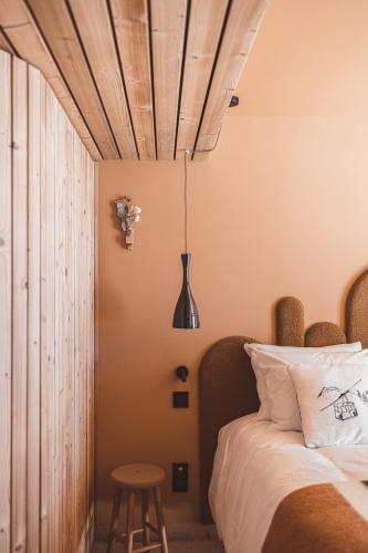 a bedroom with a bed with a wooden ceiling at La Voie Lactée in La Mongie