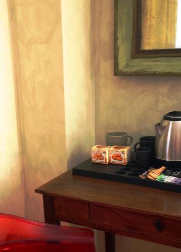 a table with a counter top with a coffee pot on it at ALBERGO BALDAZZI 1916 in Zavattarello