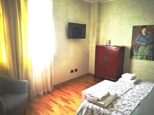 a room with a bed and a painting on the wall at ALBERGO BALDAZZI 1916 in Zavattarello