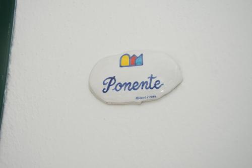 a sign that reads pomegranate on a white wall at Lucia Maison in Ischia