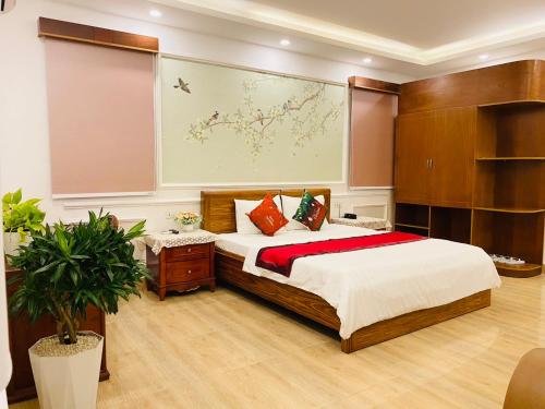a bedroom with a bed and a large painting on the wall at Nhu Y Hotel in Ho Chi Minh City