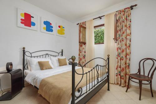a bedroom with a bed and a chair and a window at Villa Ava in Kotor