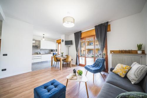 a living room with a couch and a table at Outdooredo Garda Apartment in Riva del Garda