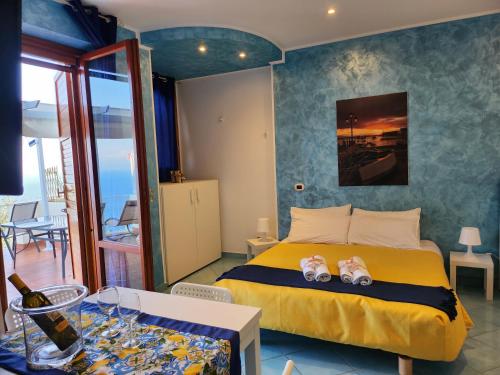 a bedroom with a bed and a table with a bottle of wine at Margiolà Amalfi in Amalfi