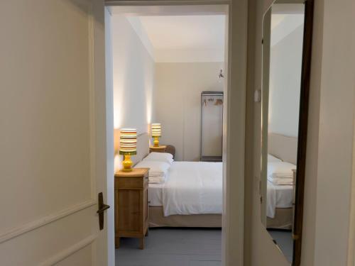 a bedroom with two beds and a mirror at CasaZavi in Belluno