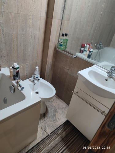 a bathroom with a sink and a toilet and a mirror at Zugliano udine in Zagliano