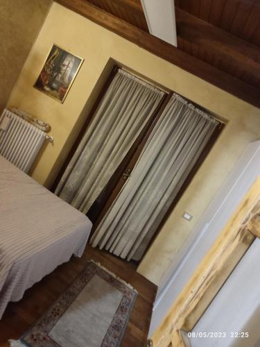 a room with a bed and a door with a window at Zugliano udine in Zagliano