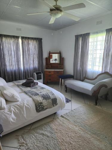 a bedroom with a bed and a ceiling fan at DE JAGTER'S NEST in Otavi
