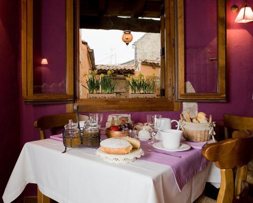 una mesa con un mantel blanco y comida en ella en El Planeta Escondido, en Losana de Pirón