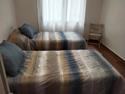 Cama ou camas em um quarto em Apartamento Aitue