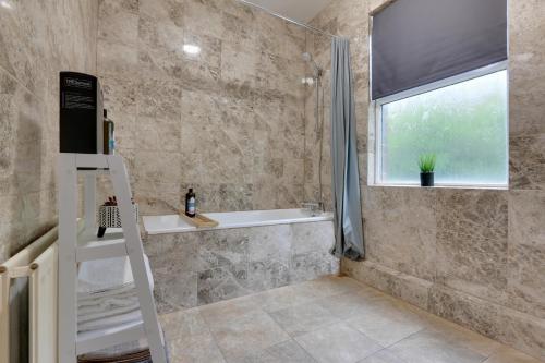 a bathroom with a shower and a sink and a ladder at Home from Home 4-Bed Townhouse - Ideal for Families, Groups & Contractors, Free Parking, Pet Friendly, Netflix in Walkly
