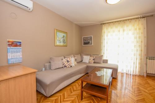 a living room with a couch and a table at APARTMANI MARIJA LJUBICA in Pag