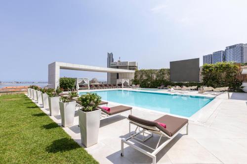 a swimming pool on the roof of a building at EPIC SANA Luanda Hotel in Luanda