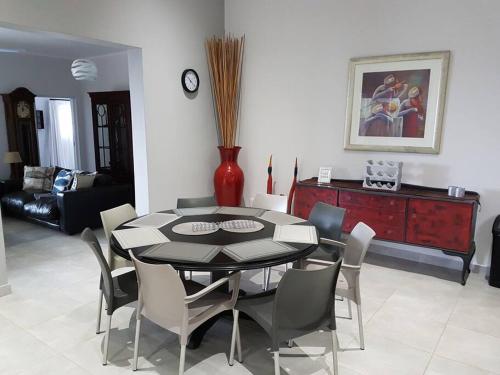 a dining room with a table and chairs at 4 Bedroom house with lovely sea views. in Ballito