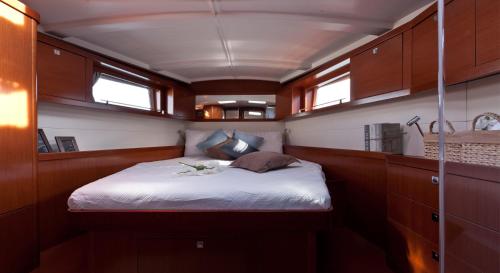 um pequeno quarto com uma cama num barco em Beneteau Oceanis 48 Sailboat - Coron em Coron