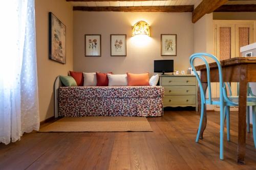 a living room with a couch and a desk at Musella Winery & Relais in San Martino Buon Albergo