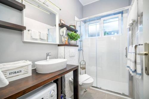 a bathroom with a toilet and a sink and a shower at Apartman Megi in Šibenik