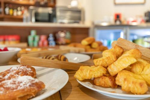 a table with two plates of pastries and other pastries at Maison Marineta in Denia