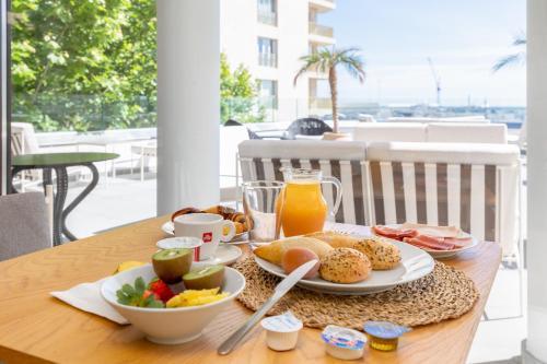 a table with a tray of breakfast food on it at Maison Marineta in Denia
