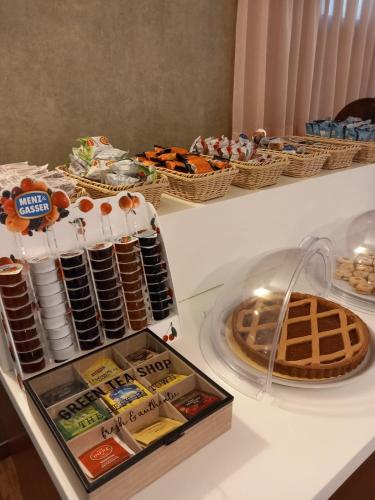 a table with cookies and waffles and other food at Hotel Corallo in Fano