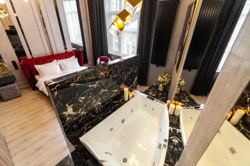 a bathroom with a bath tub in a room at ARISTO Jacuzzi Hotel in Lviv