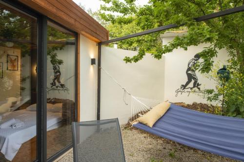 a hammock in the backyard of a house at Nomade Caravan Camping in Fethiye